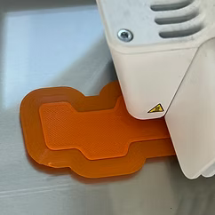intuition.webp An orange code block being 3D printed